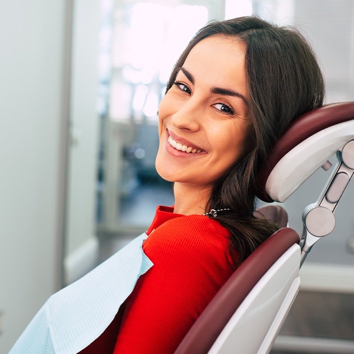 Happy woman in dental treatment chair