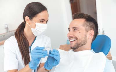 patient learning about maintenance of Invisalign in Grove City