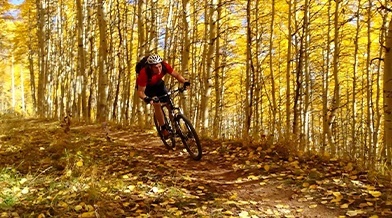 Doctor Merrell biking in the woods