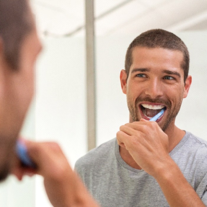 man brushing his teeth to prevent dental emergencies in Grove City